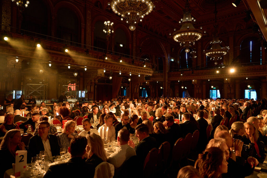 Overview image from the gala dinner at Berns with a fully set room and hundreds of guests in a festive mood under the crystal chandeliers.
